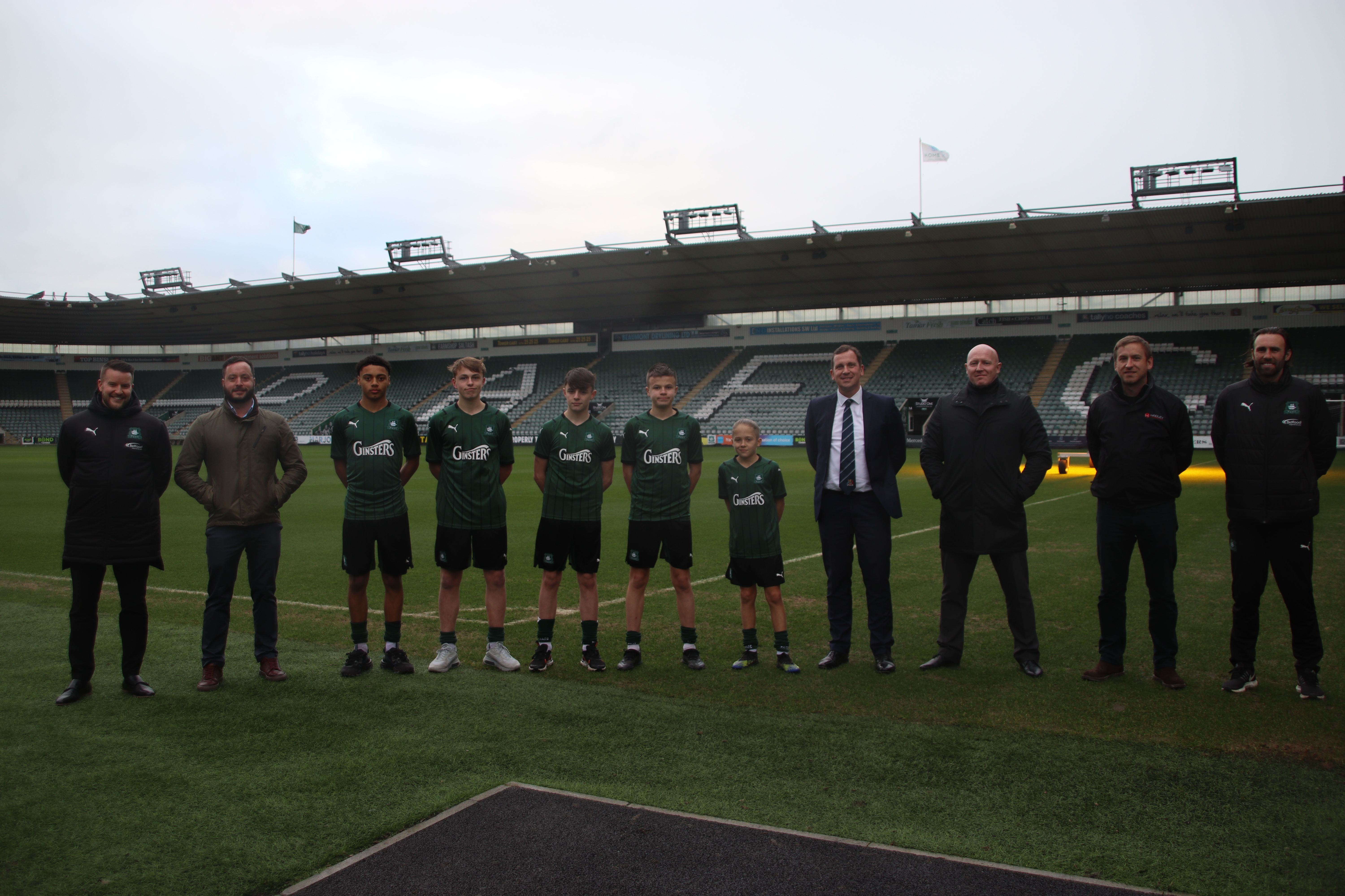 Academy players stand alongside proud sponsors at Home Park