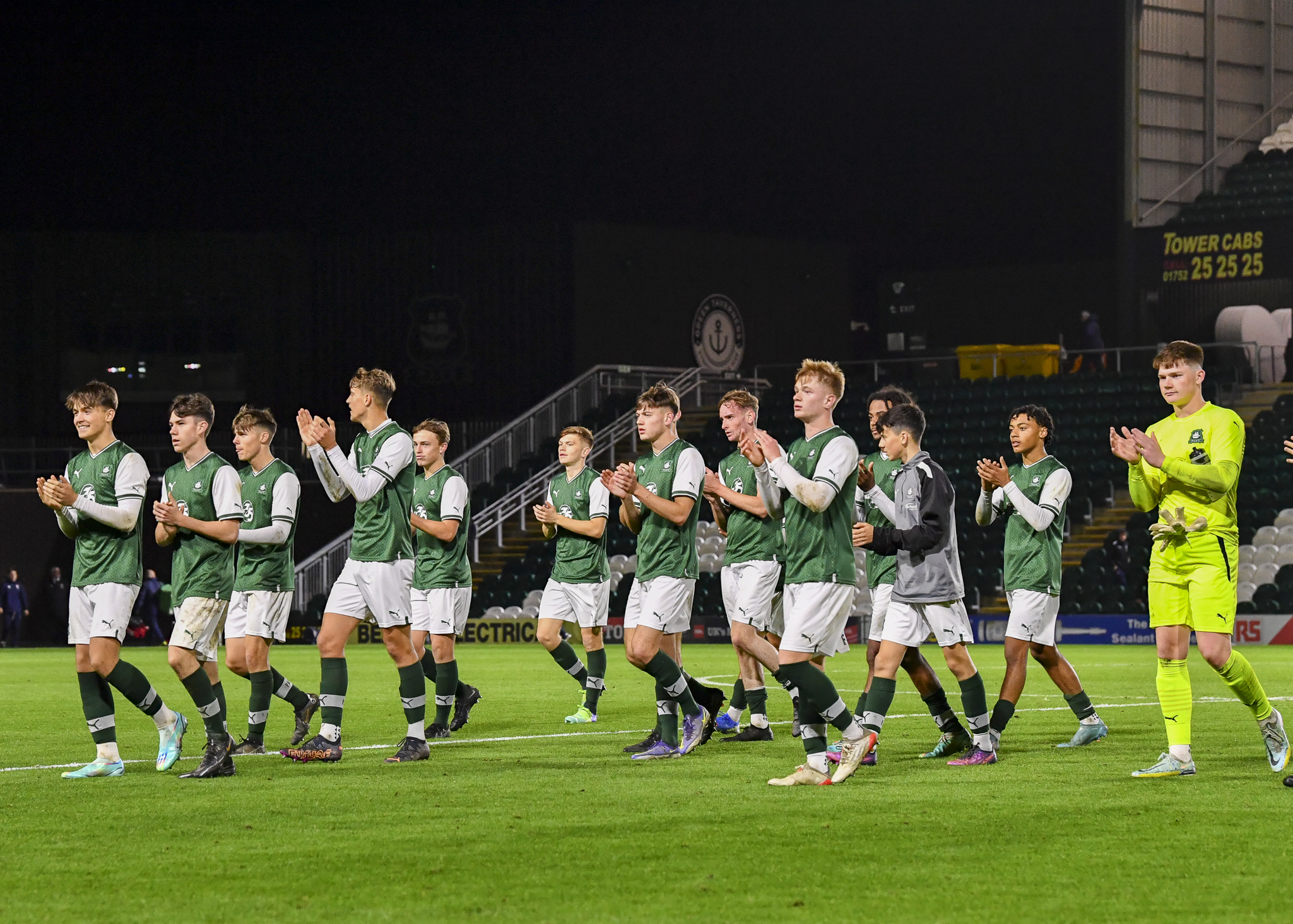 under-18 players applaud supporters at Home Park