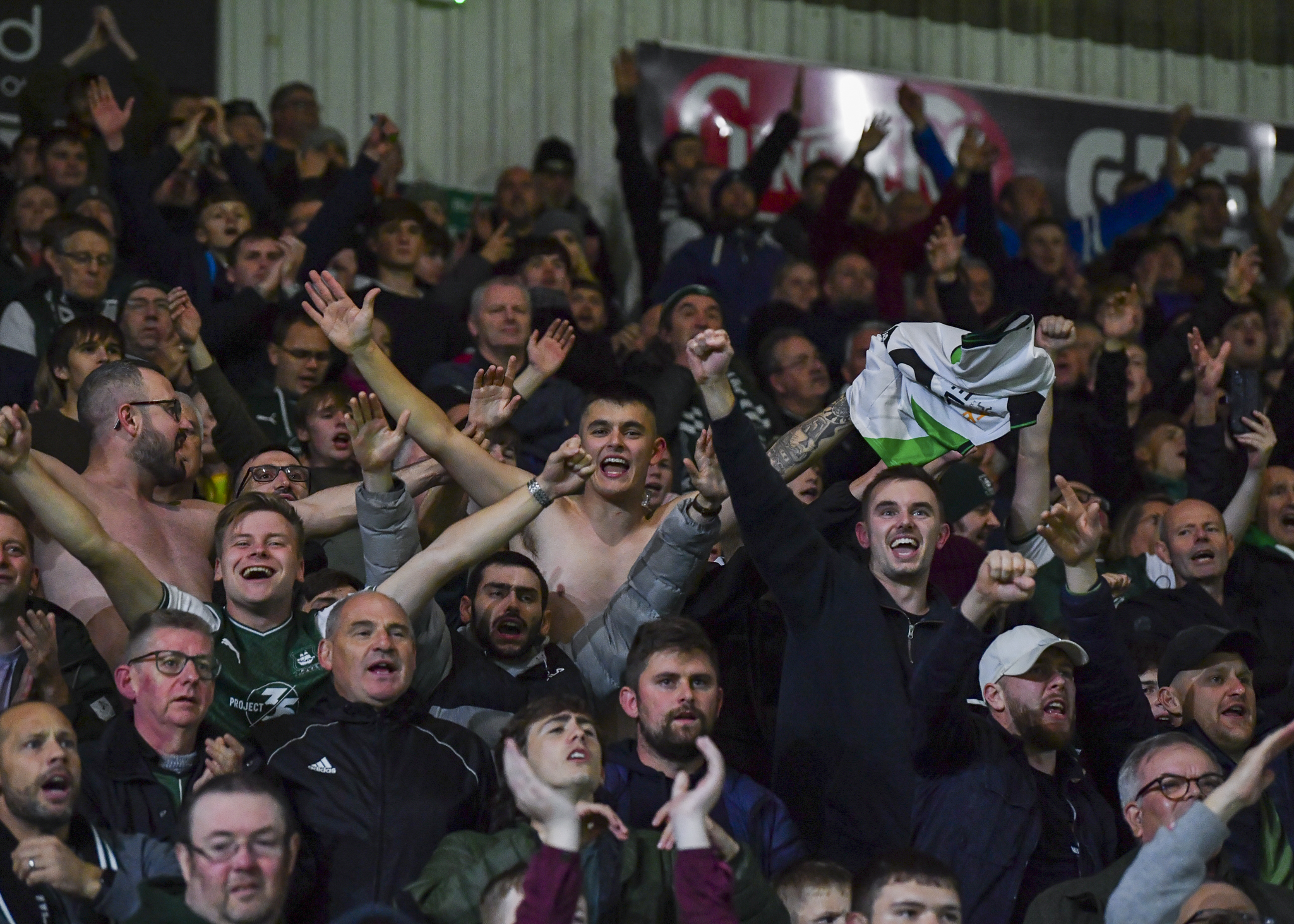 Supporters celebrate win under the lights at Home Park