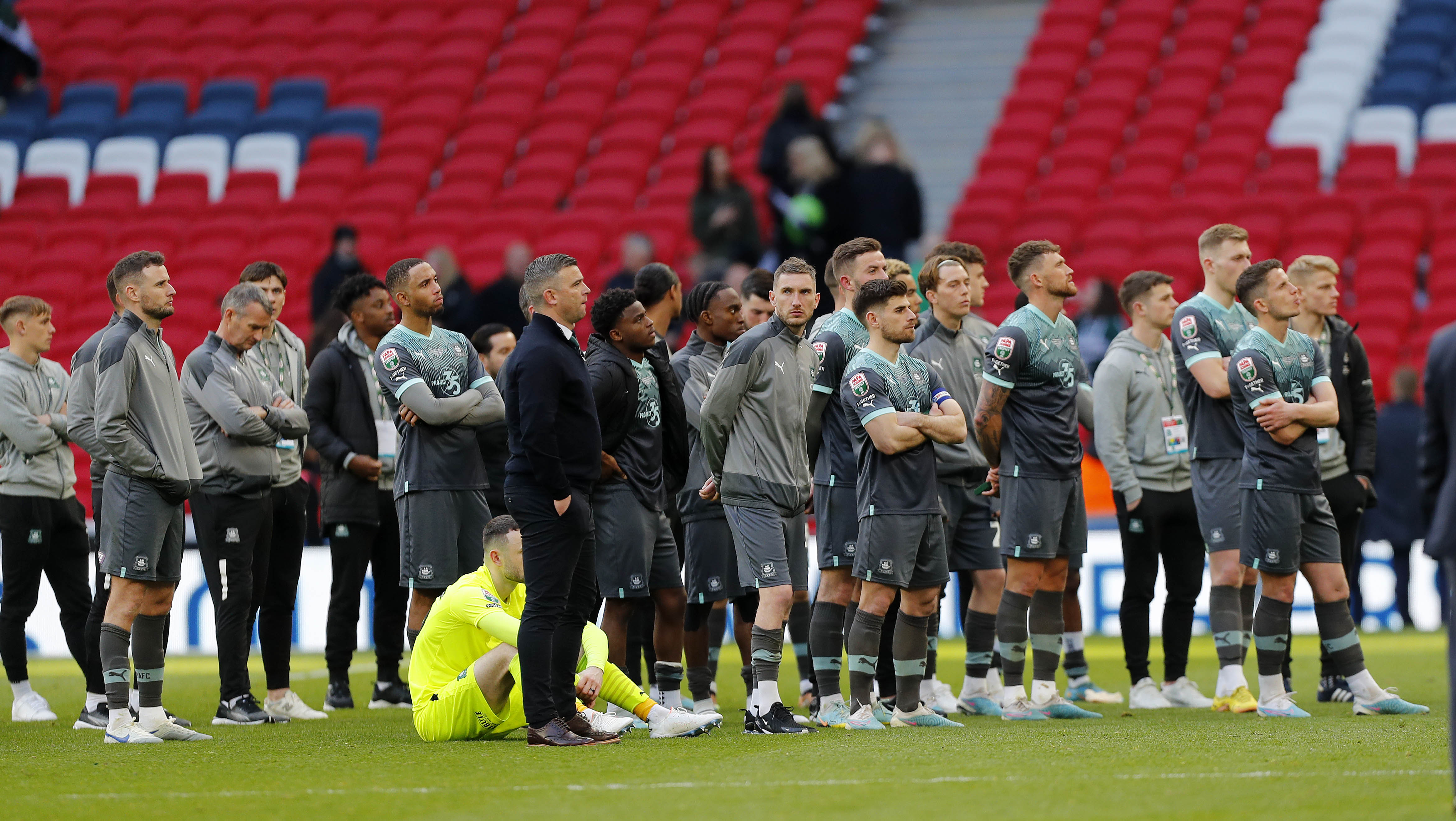 Players watch. on as Bolton celebrate