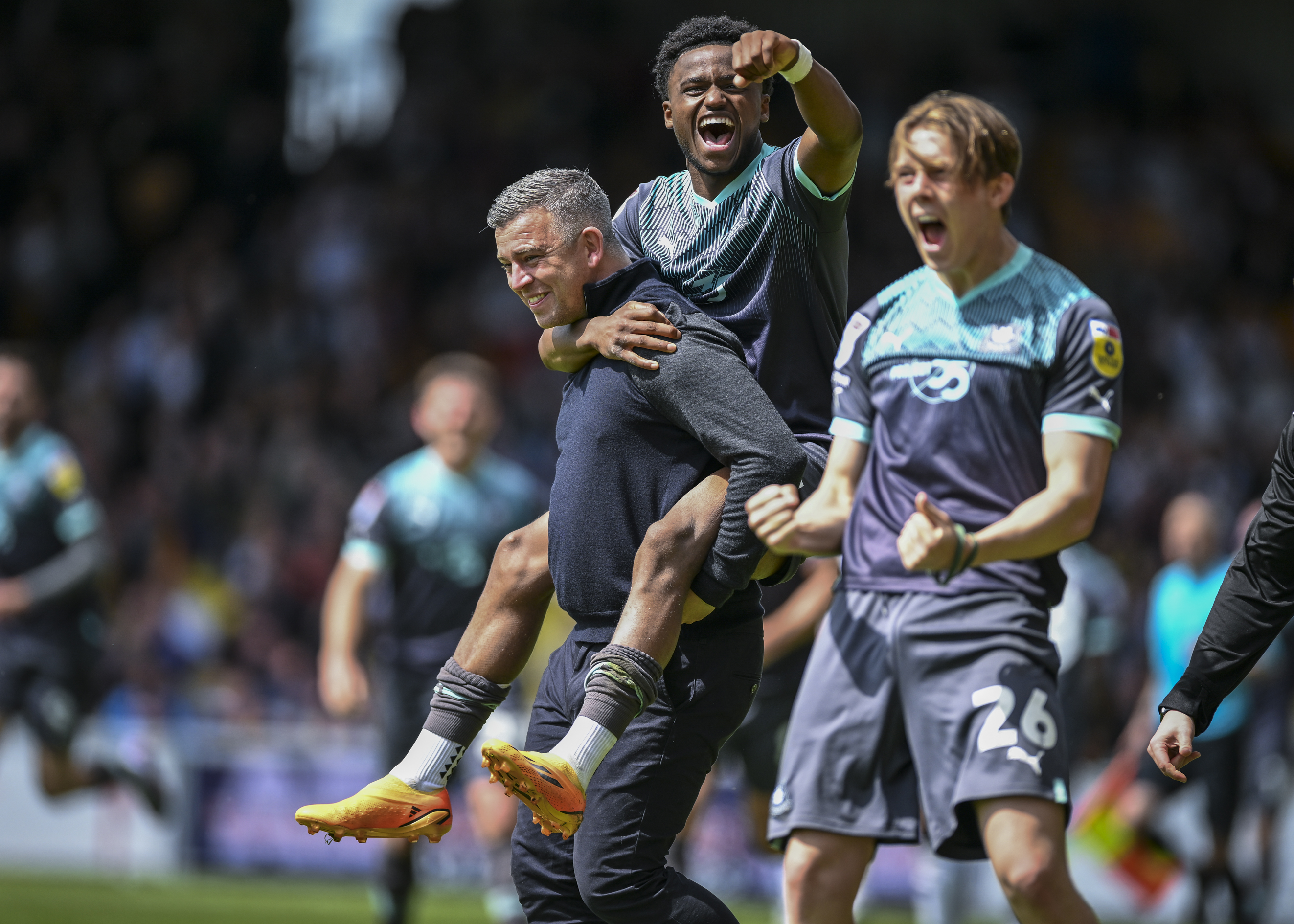 Bali Mumba, Callum Wright and Steven Schumacher celebrate at the final whistle 