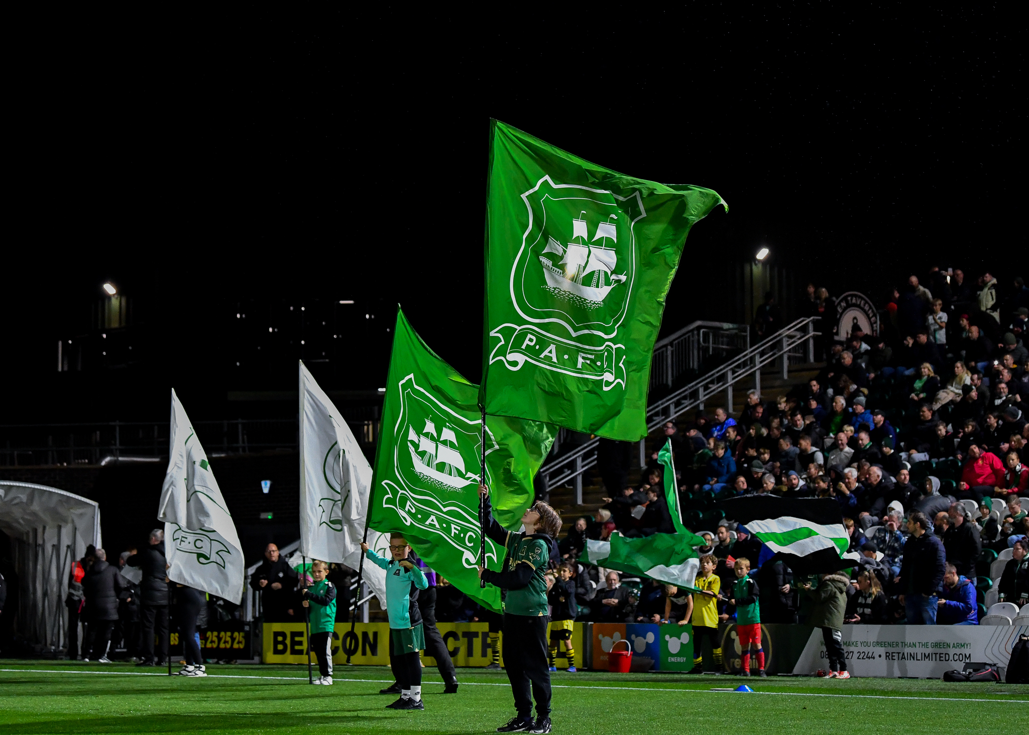 flags being held at Home Park