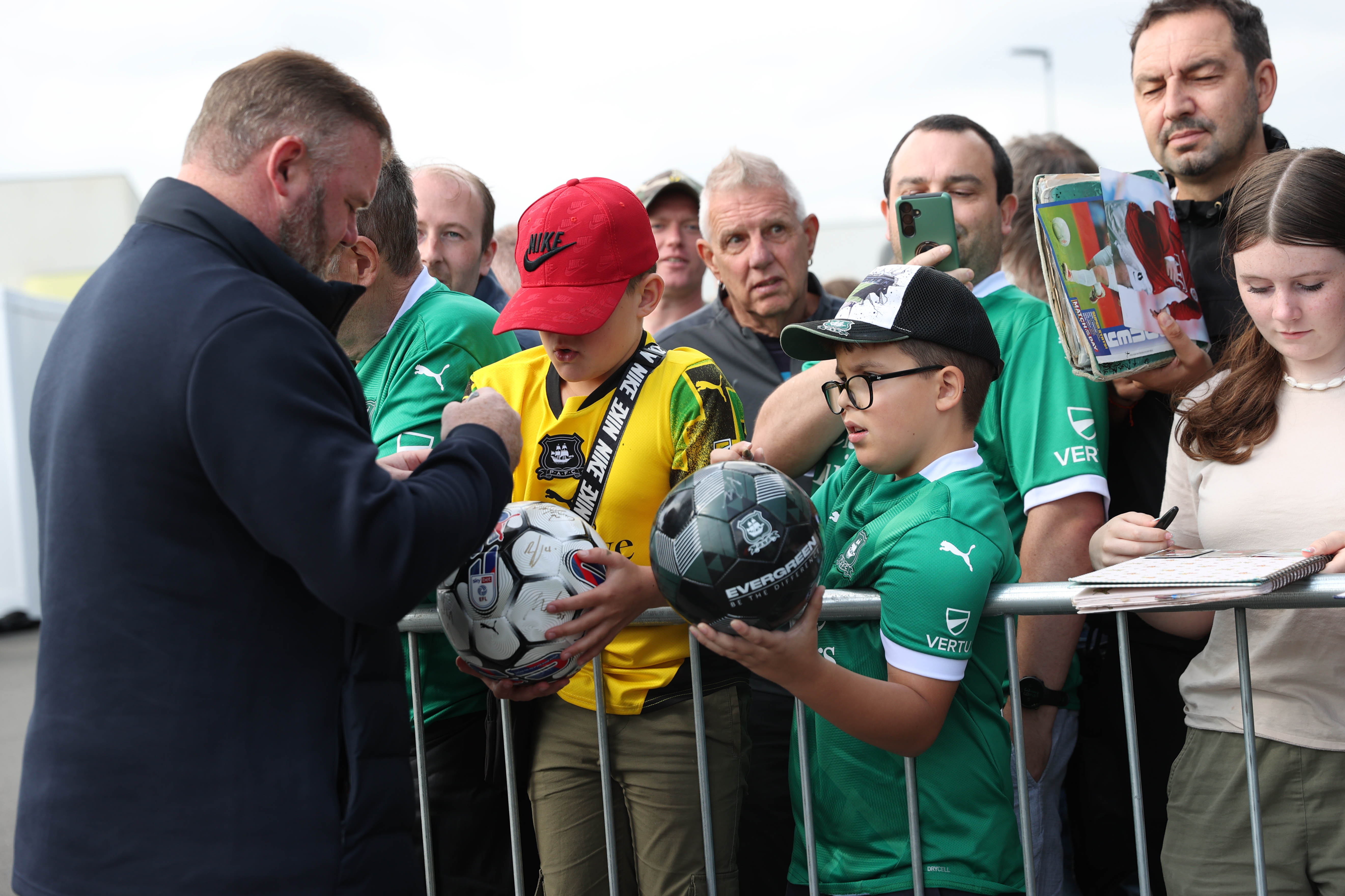 Wayne Rooney signs autographs