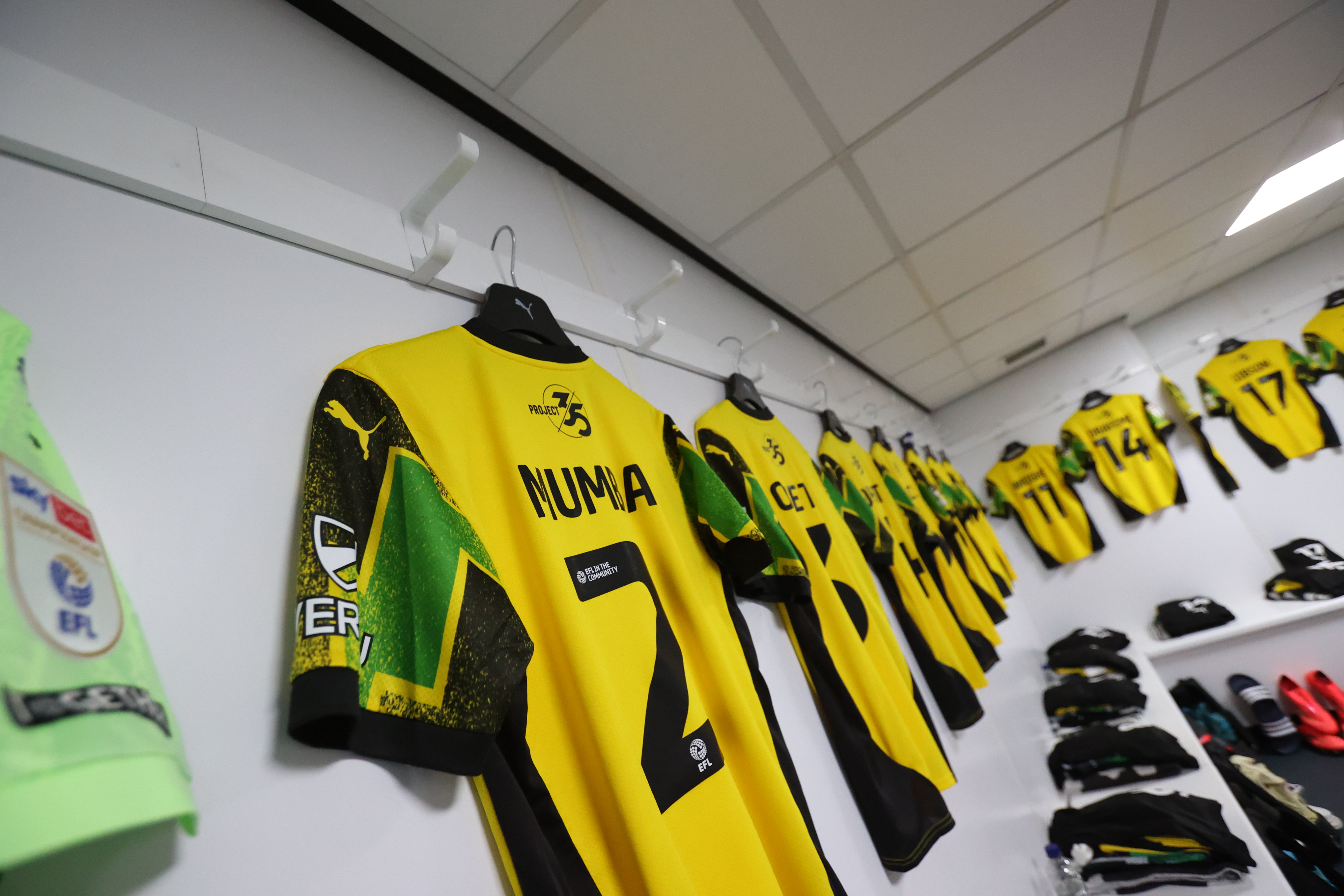 Argyle shirts hang in the changing room 