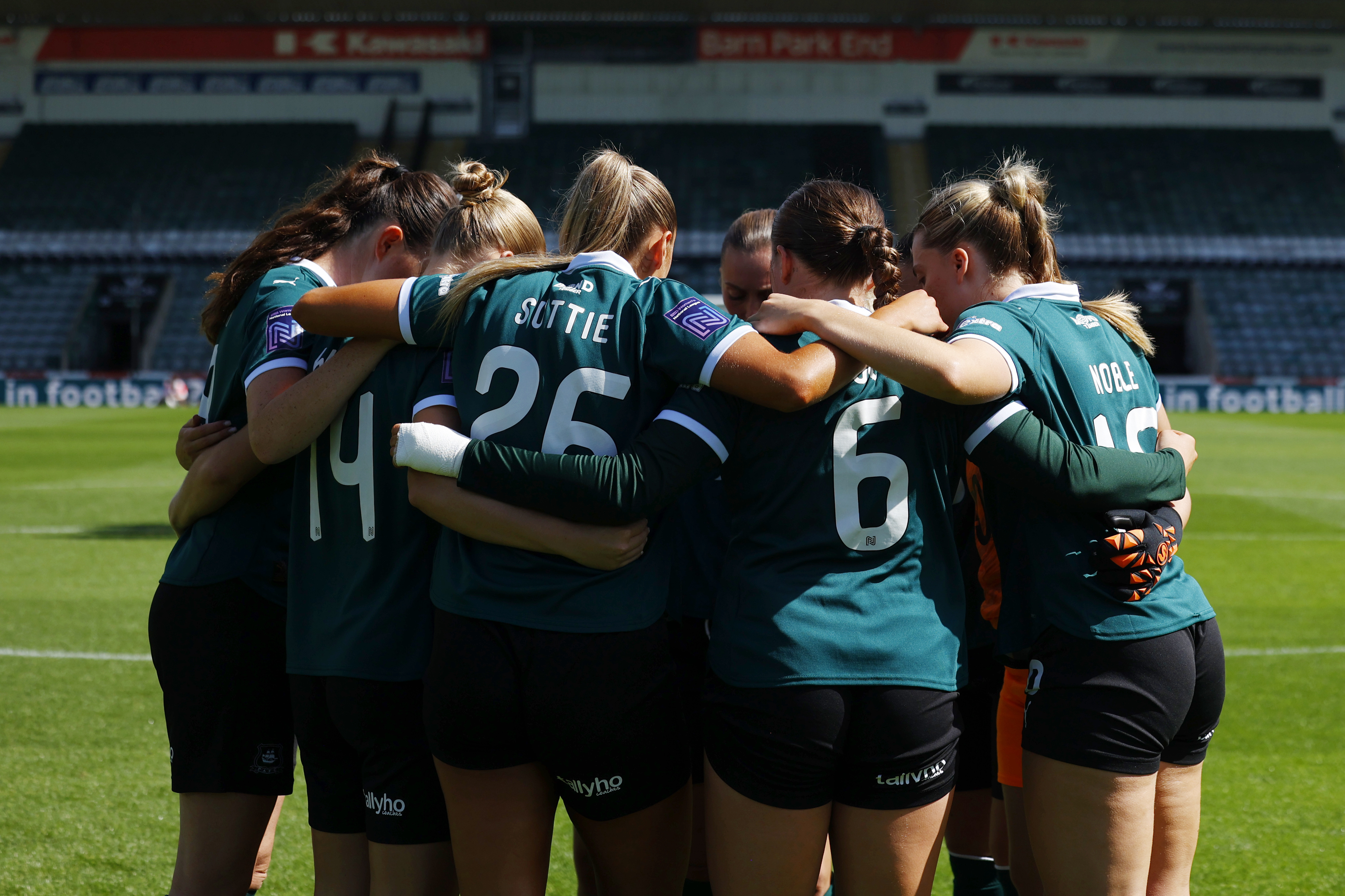 Women's team huddle at Home Park.
