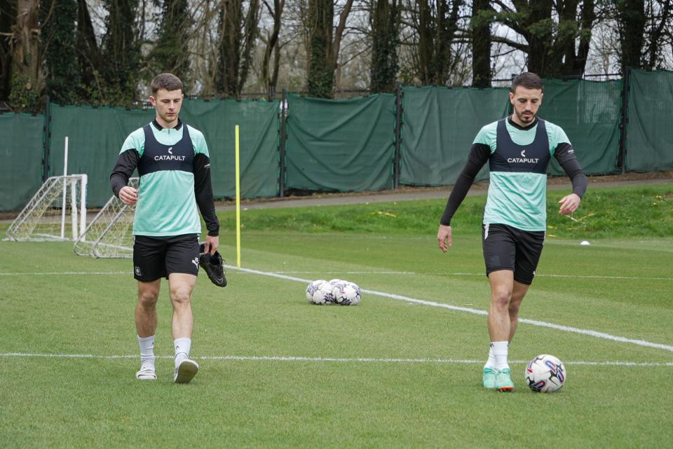 Adam Randell and Julio Pleguezuelo walk into training.