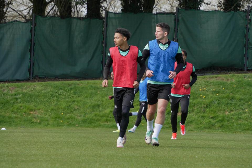Caleb Roberts and Jordan Houghton running during a drill.
