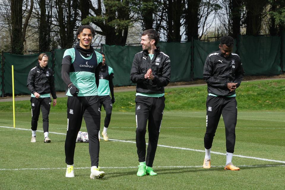 Ashley Phillips, Ryan Hardie and Mustapha Bundu walk into training.