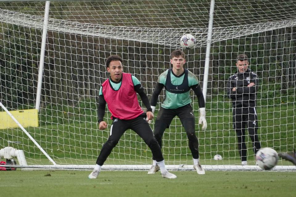 Matty Sorinola and Mike Cooper watch the incoming shot.