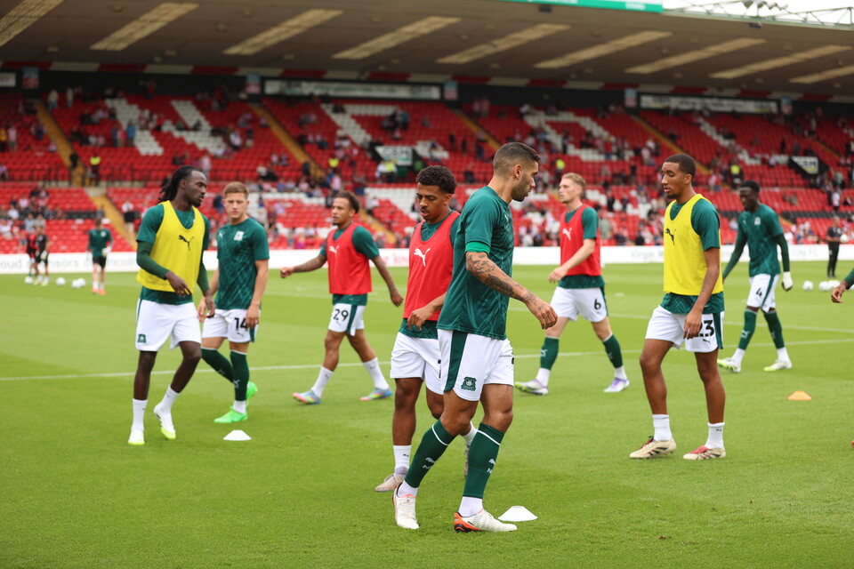 Argyle players warm up at the LNER Stadium, Lincoln