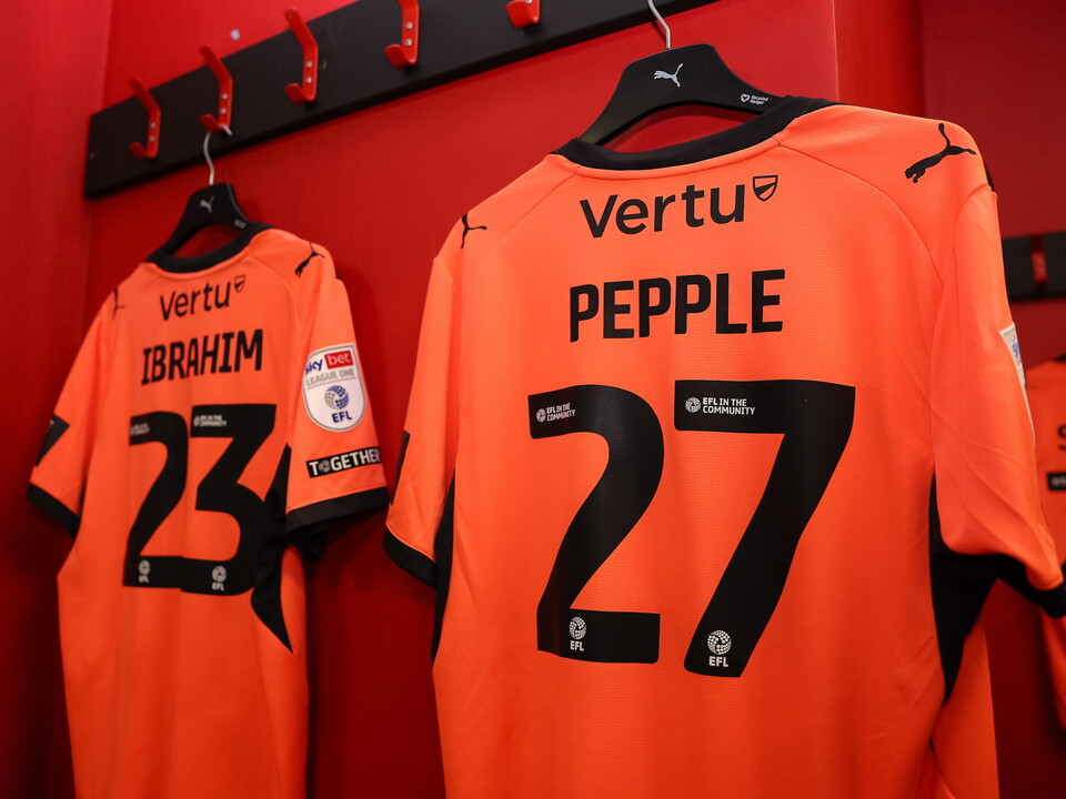 Orange football shirts with the names 'BRAHIM' and 'PEPPLE' and numbers '23' and '27' respectively.