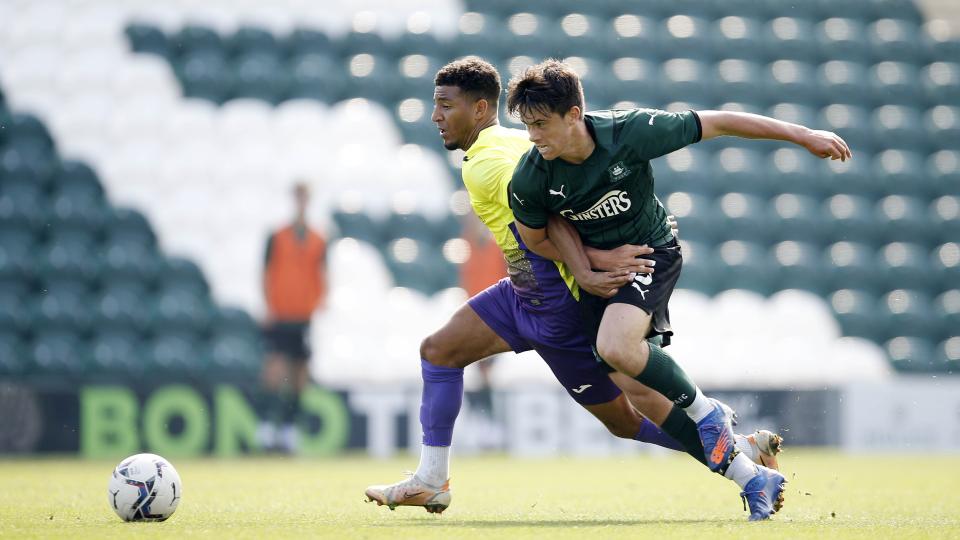 Oscar Rutherford tackles in the Premier League Cup