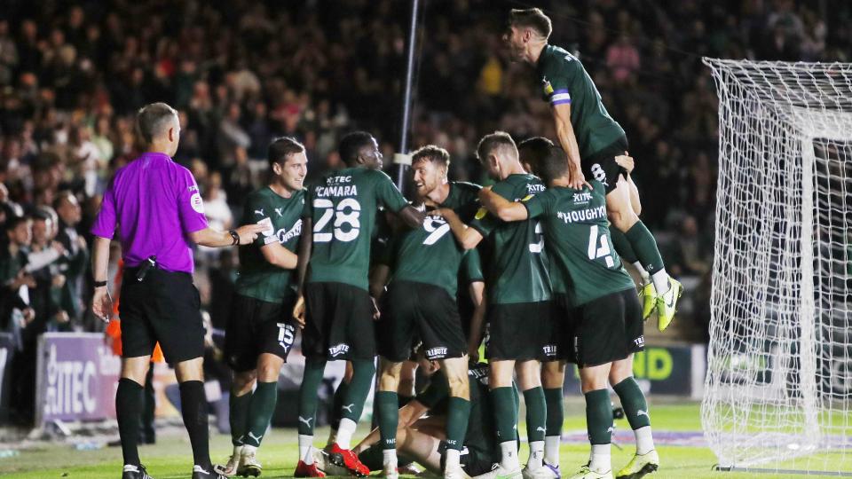 Player celebrate against Cambridge United