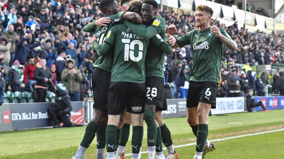 Players celebrate scoring a goal