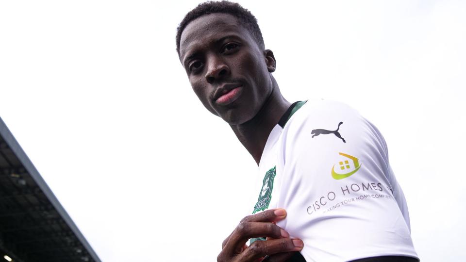 Panutche Camara showing off shirt sleeve