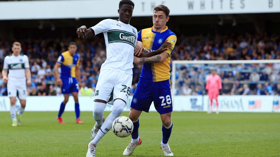 Panutche Camara scrapping for the ball at Wycombe