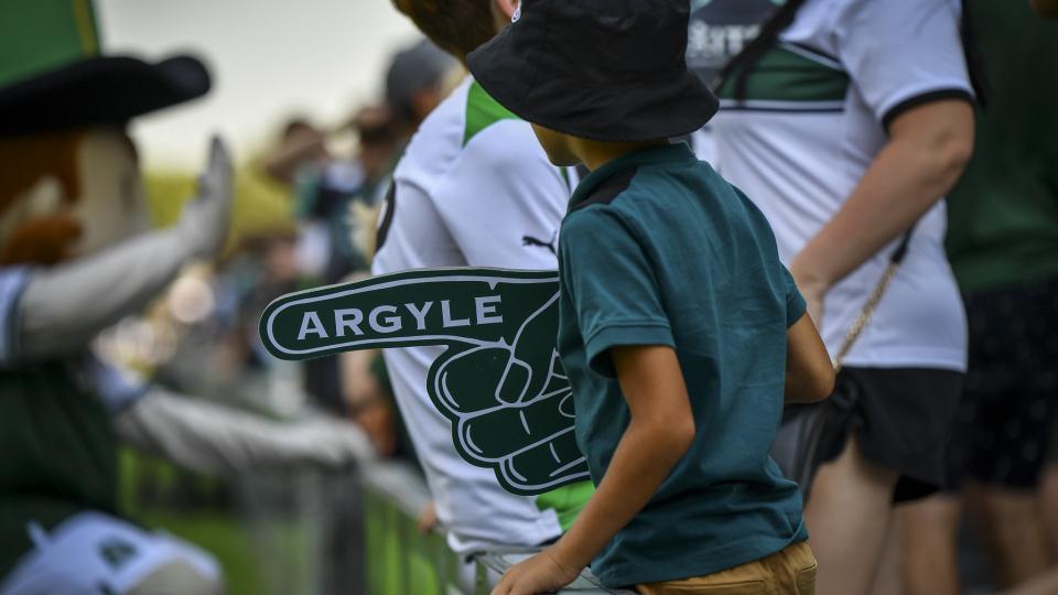 Young supporter with a foam finger at Home Park