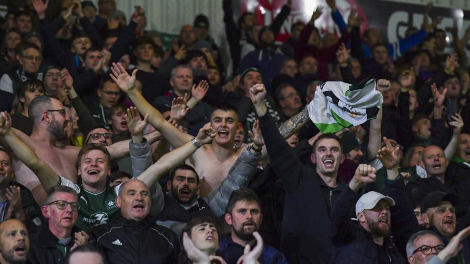 Supporters celebrate win under the lights at Home Park
