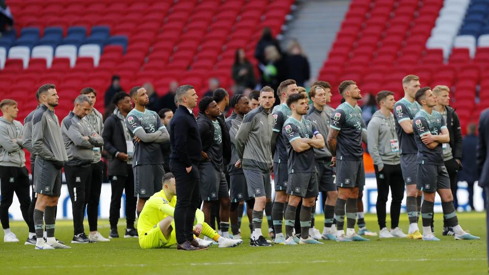 Players watch. on as Bolton celebrate