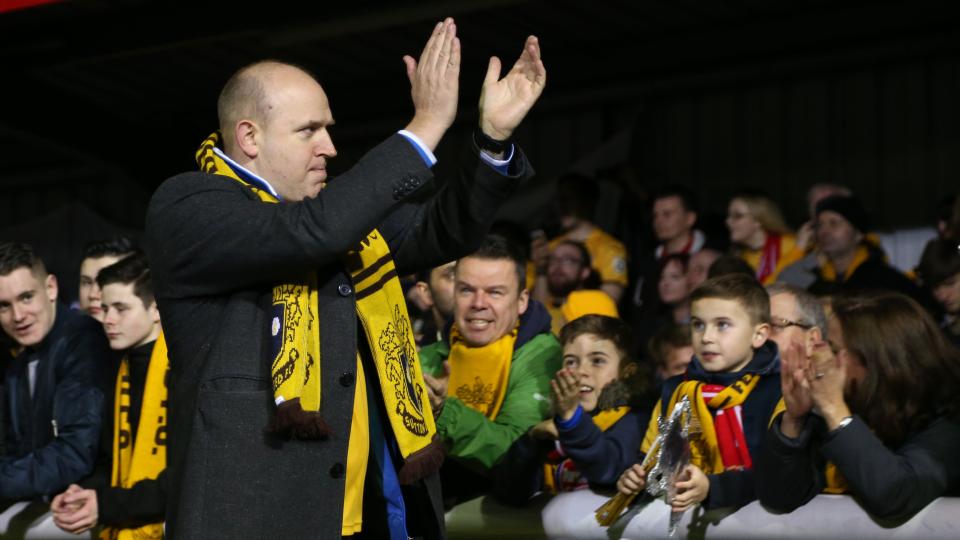Comedian Tim Vine clapping Sutton United fans