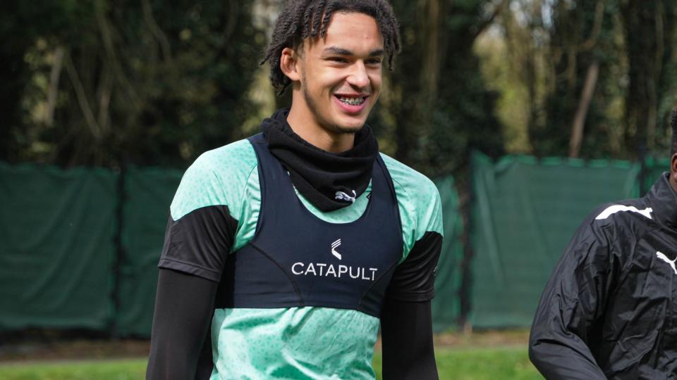 Ashley Phillips smiles as he walks into training.