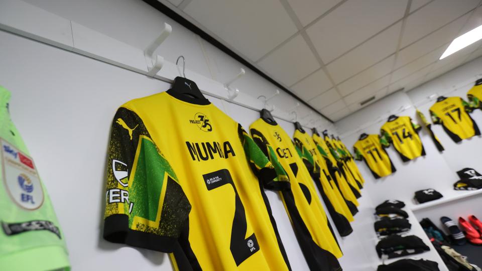 Argyle shirts hang in the changing room 