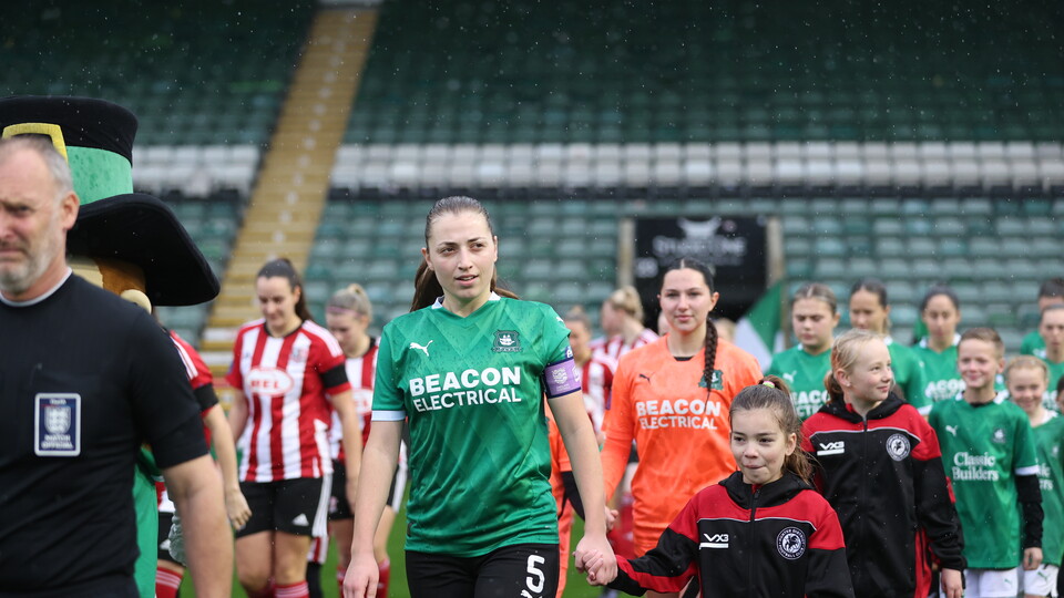 Giota Papaioannou leads out Argyle in their new kit with Beacon Electrical on it