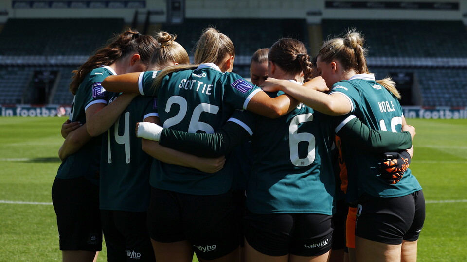 Women's team huddle at Home Park.