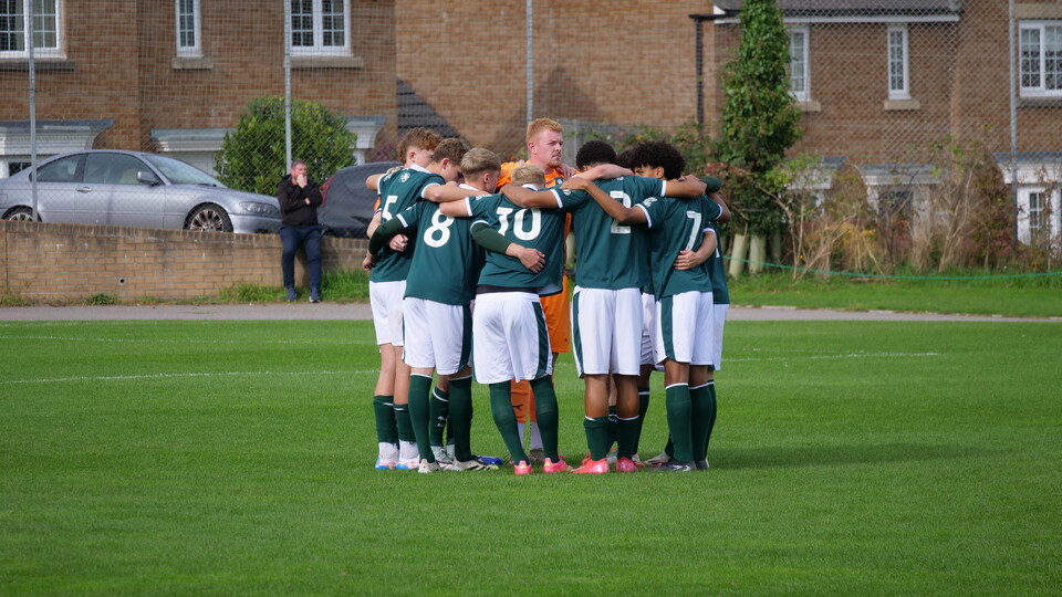 Under-18s team huddle.