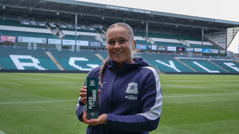 Layla Proctor holding her March Player of the Month trophy at Home Park.