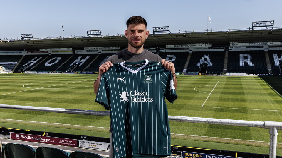 A photo showing Joe Edwards at Home Park, holding the Argyle 2026/27 home shirt.