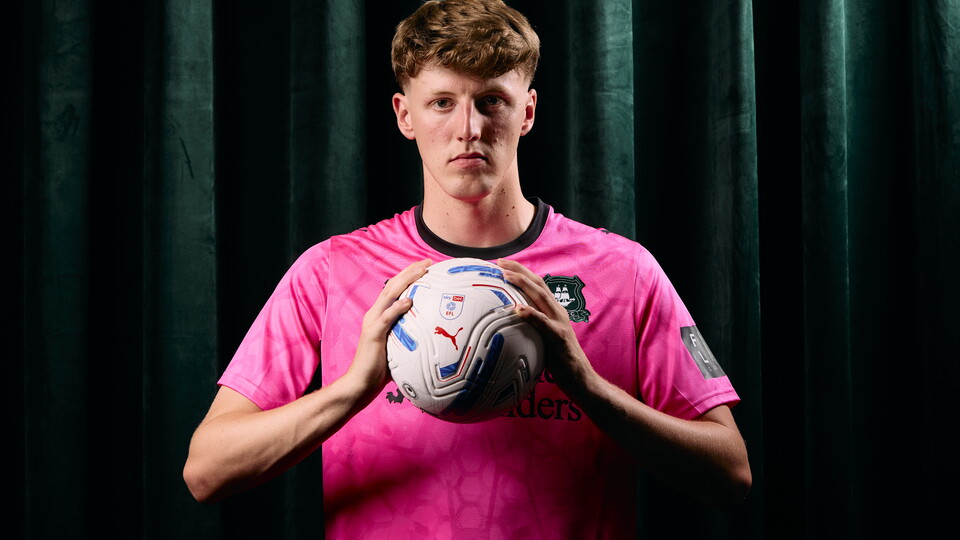 James Storer poses with a football in his hands